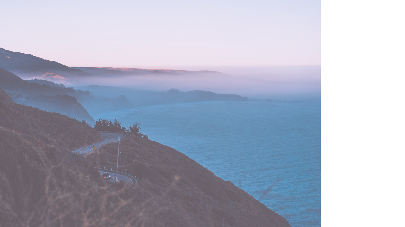 Aerial photograph overlooking the hazy Pacific Coast Highway and ocean.